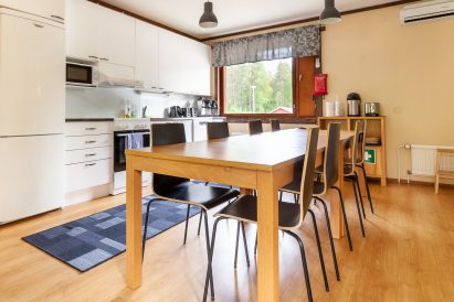 The kitchen on the upper floor of Evo Grand Villa is located as an extension of the main hall. There is a separate dining area in the main hall.