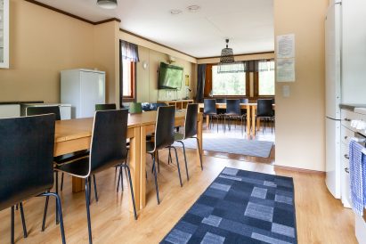 The kitchen on the upper floor of Evo Grand Villa is located as an extension of the main hall. There is a separate dining area in the main hall.