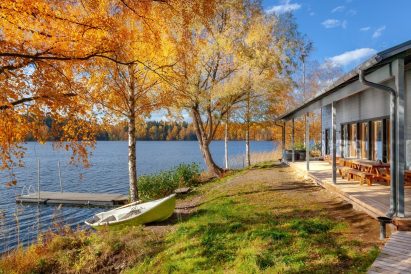 Aulanko Lake Villa's pier, boat, and terrace overlooking the shores of Lake Aulangonjärvi.