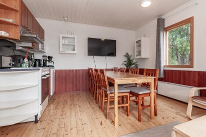 In the living room and kitchenette of Aulanko Lakeside's Small Villa, there is space at the table for dining or a meeting for 8-9 people.