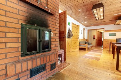 The lobby of the main building at Evo Ruuhijärvi is adorned with a brick-built stove.