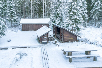 In the courtyard of Evo Wilderness Villa, there is a wilderness-inspired shelter and a fireplace.