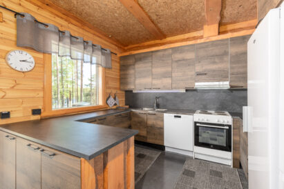 The kitchen at Loppi Luxus is equipped with a dishwasher, stove/oven, coffee maker and water kettle, toaster, microwave, refrigerator, and refrigerator/freezer.