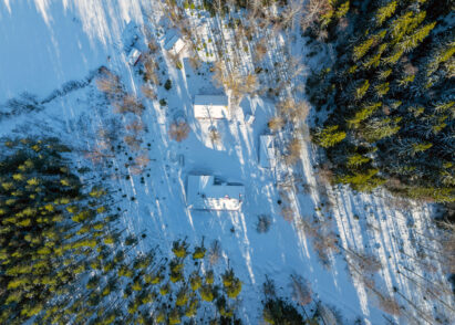 The buildings of Evo Ruuhijärvi in the late afternoon spring-winter sun.